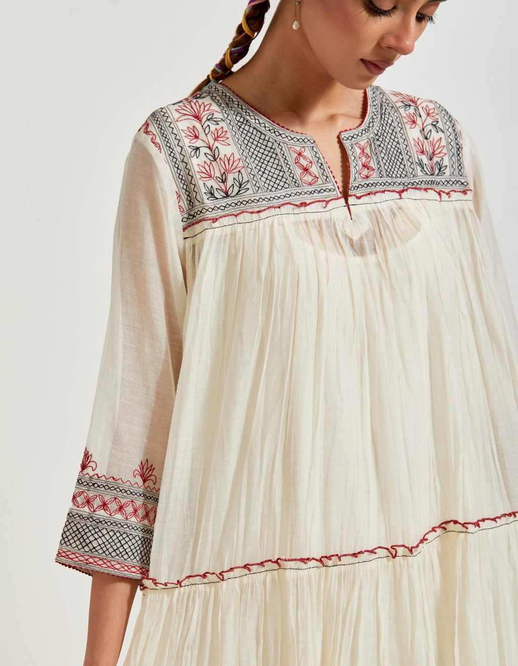 Off white three-tiered cotton chanderi kurta dress set with 3/4 sleeves, highlighted with quilted yoke in front and back.