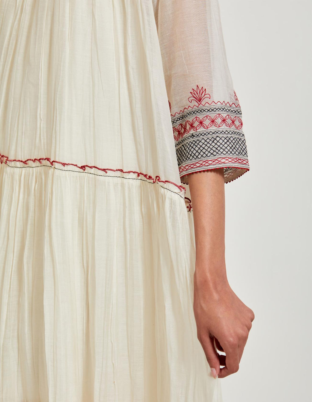 Off white three-tiered cotton chanderi kurta dress set with 3/4 sleeves, highlighted with quilted yoke in front and back.