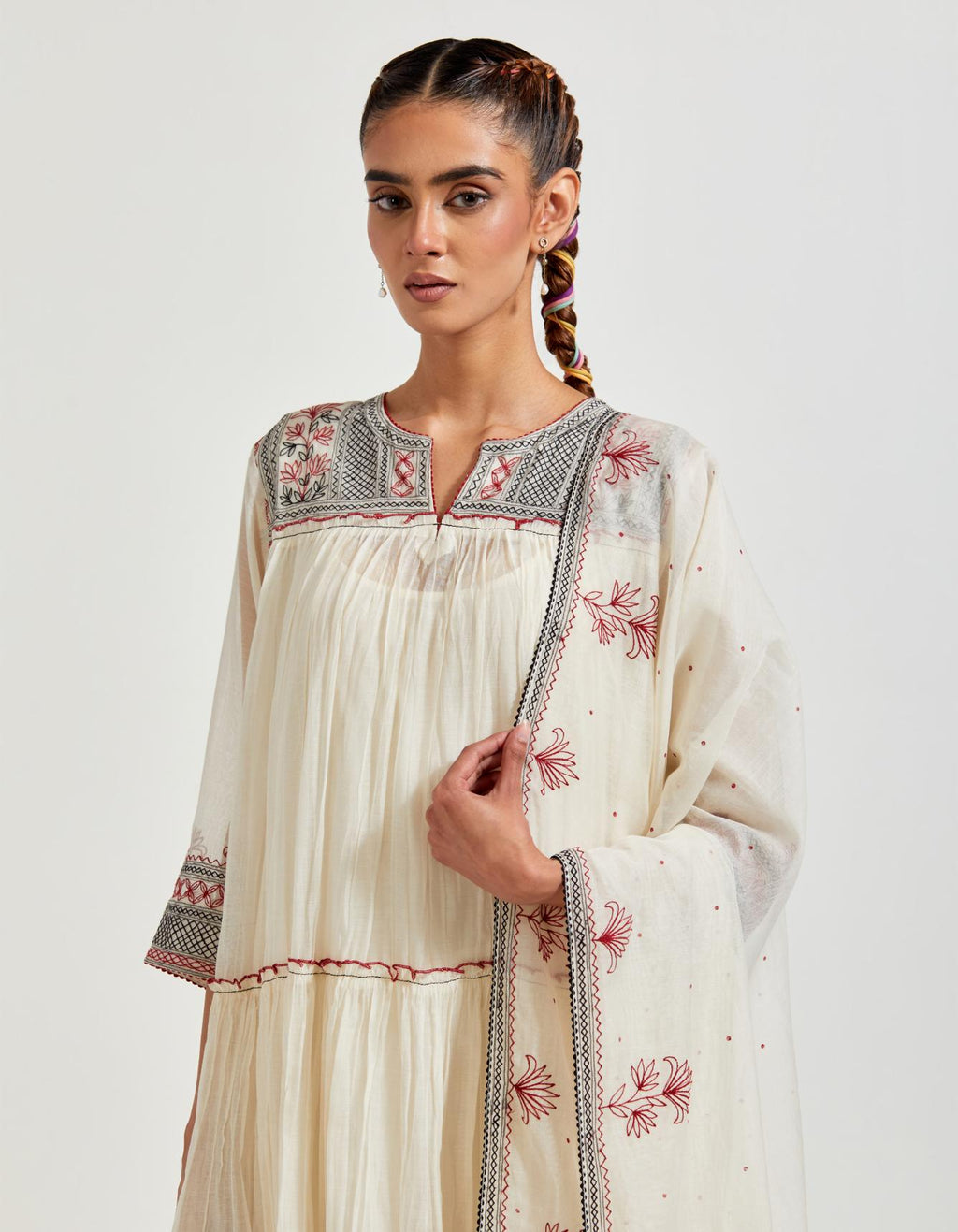 Off white three-tiered cotton chanderi kurta dress set with 3/4 sleeves, highlighted with quilted yoke in front and back.