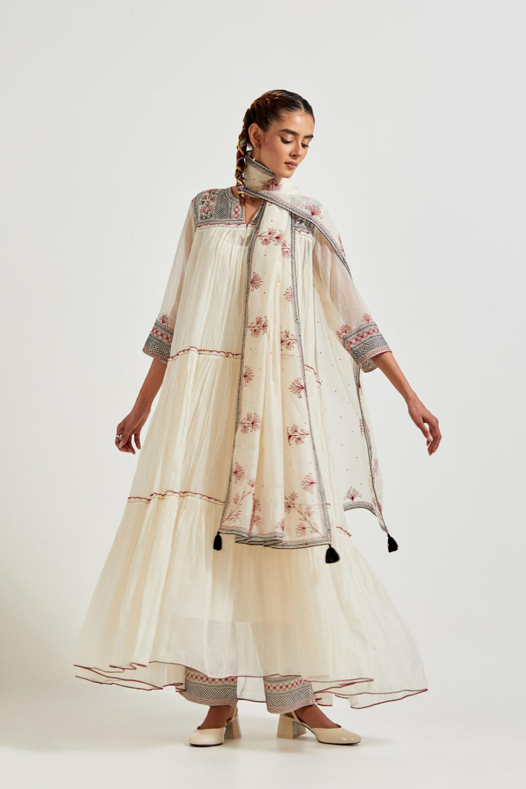 Off white three-tiered cotton chanderi kurta dress set with 3/4 sleeves, highlighted with quilted yoke in front and back.