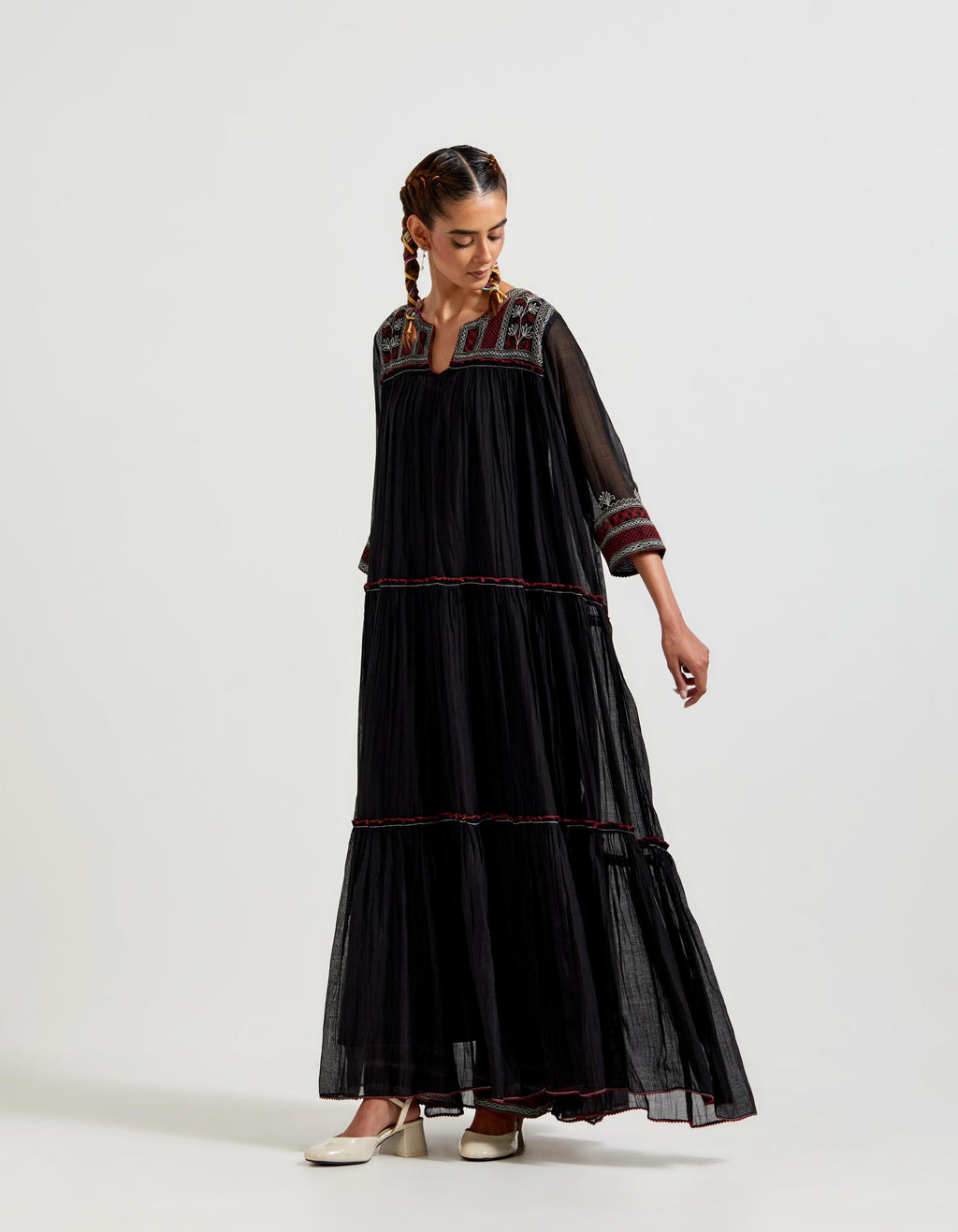 Black three-tiered cotton chanderi kurta dress set with 3/4 sleeves, highlighted with quilted yoke in front and back.