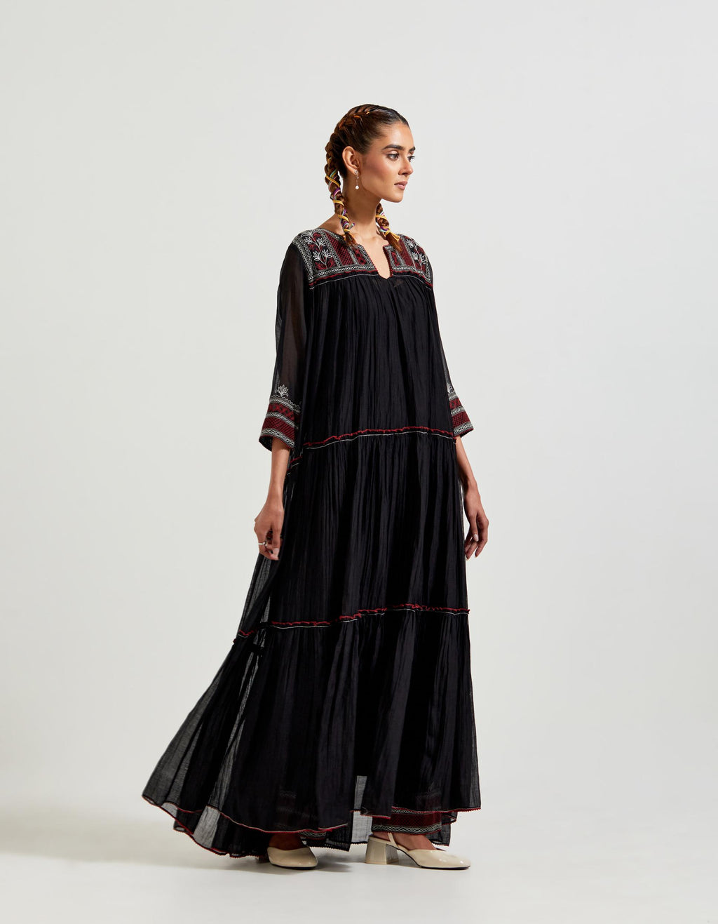 Black three-tiered cotton chanderi kurta dress set with 3/4 sleeves, highlighted with quilted yoke in front and back.