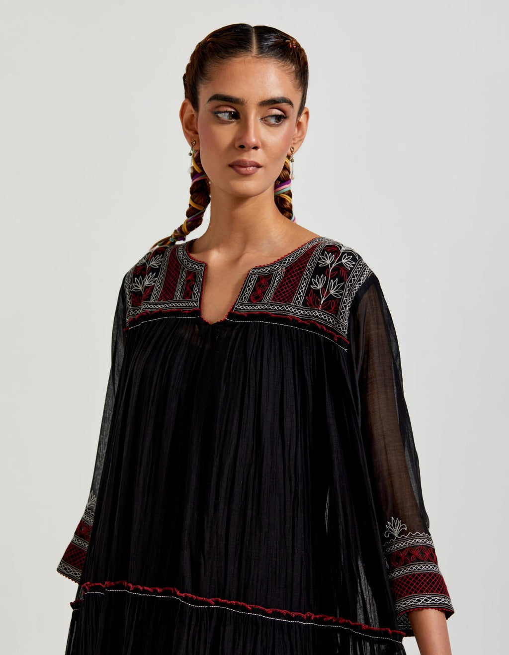 Black three-tiered cotton chanderi kurta dress set with 3/4 sleeves, highlighted with quilted yoke in front and back.