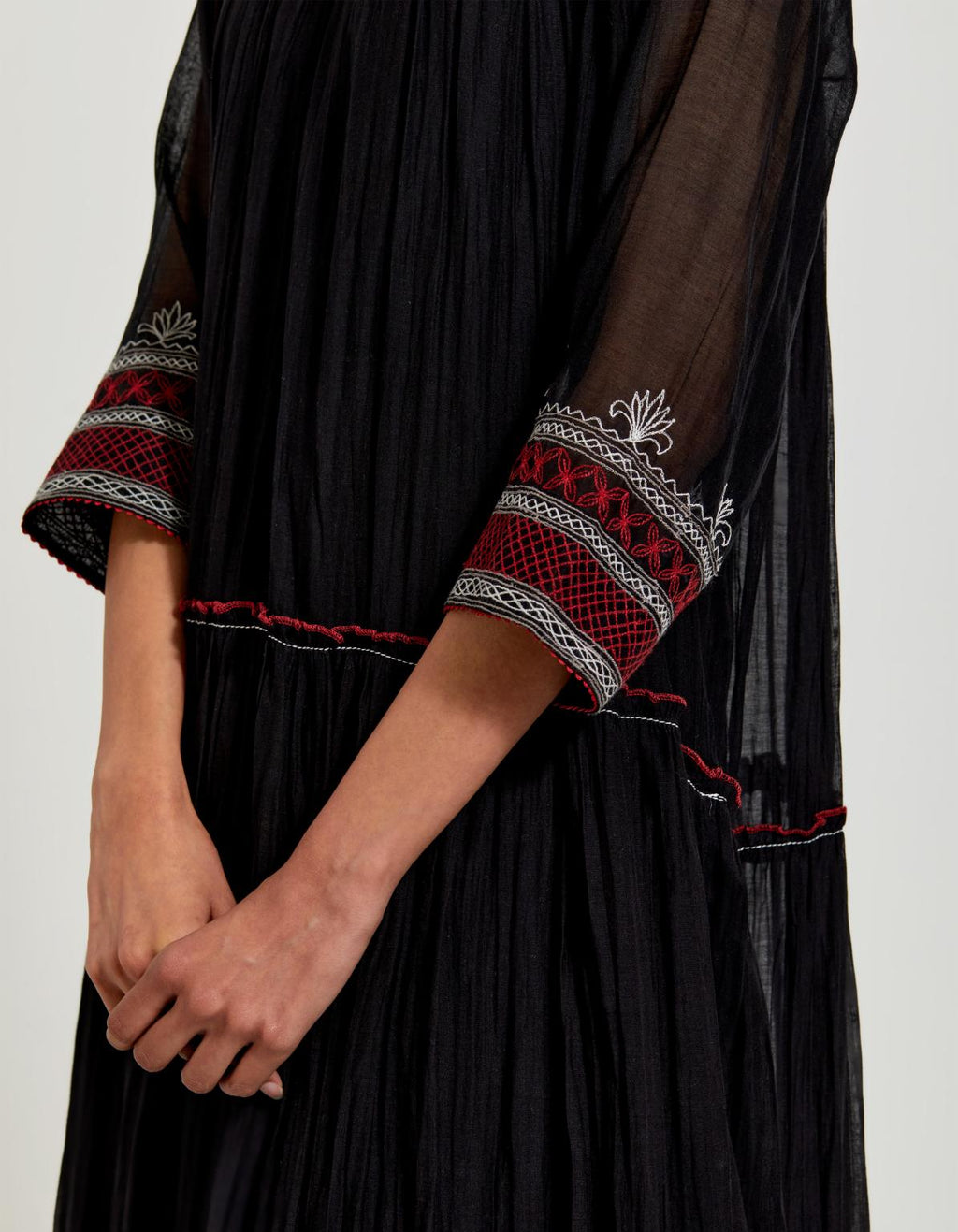 Black three-tiered cotton chanderi kurta dress set with 3/4 sleeves, highlighted with quilted yoke in front and back.