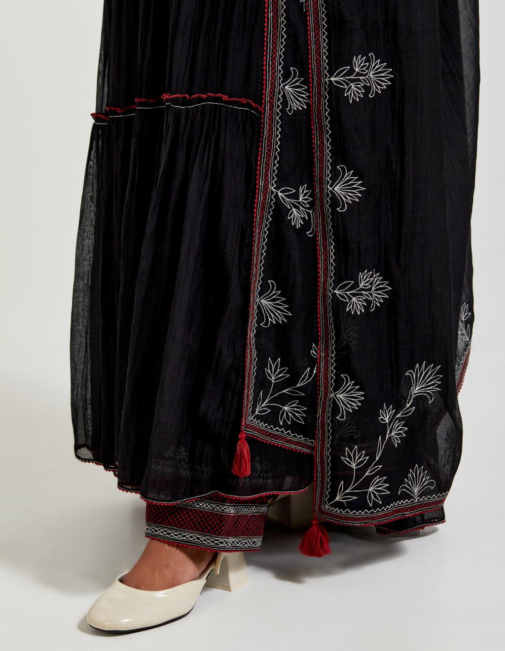 Black three-tiered cotton chanderi kurta dress set with 3/4 sleeves, highlighted with quilted yoke in front and back.