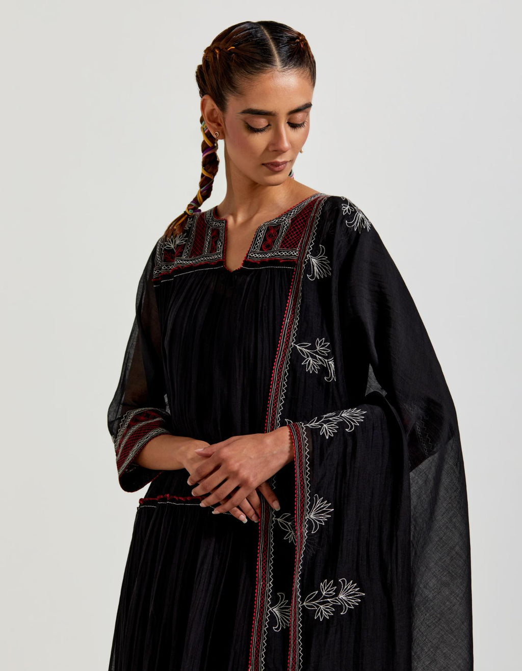 Black three-tiered cotton chanderi kurta dress set with 3/4 sleeves, highlighted with quilted yoke in front and back.