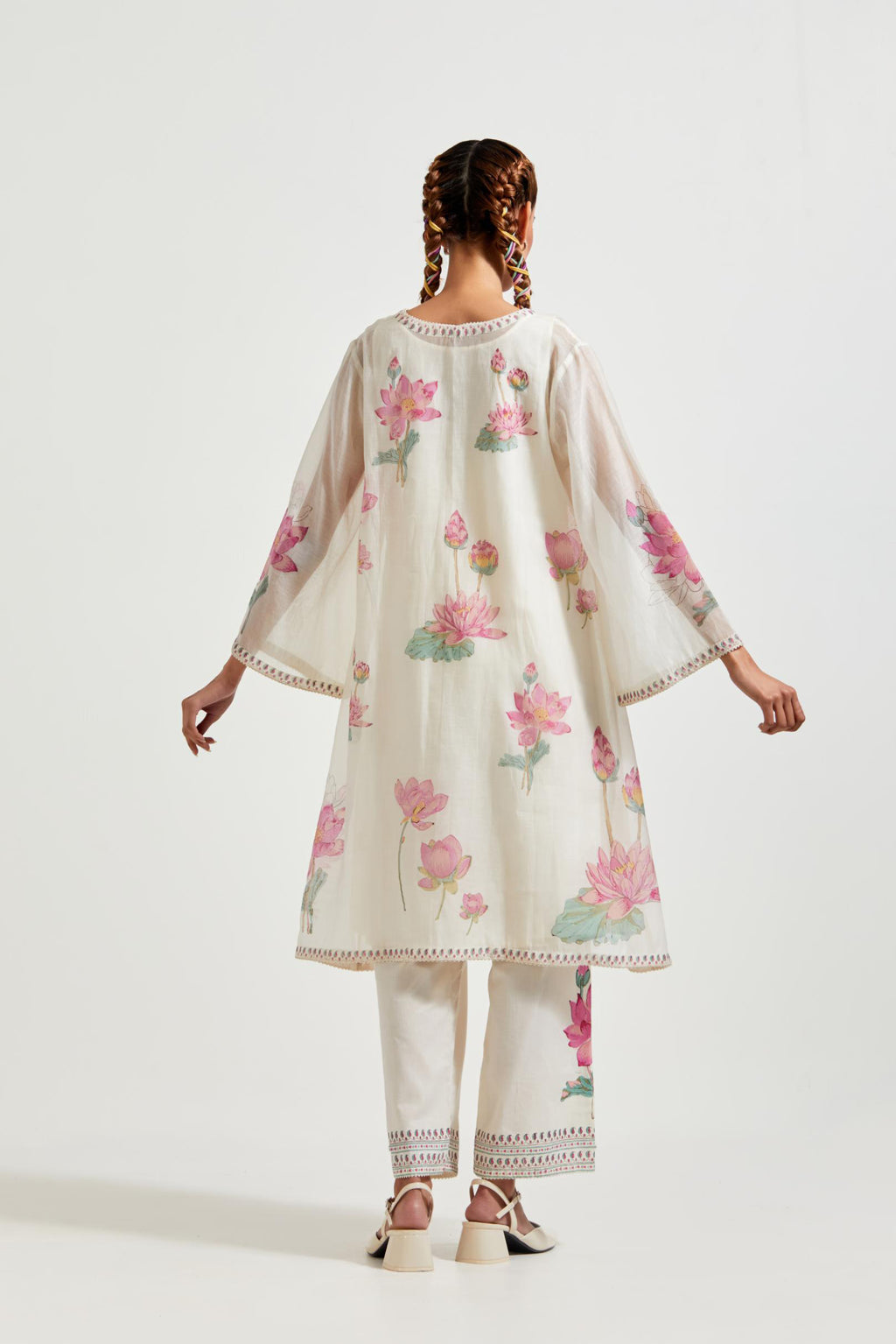 Off white cotton chanderi A-line kurta set features with all-over pink and green lotus flower hand block print.