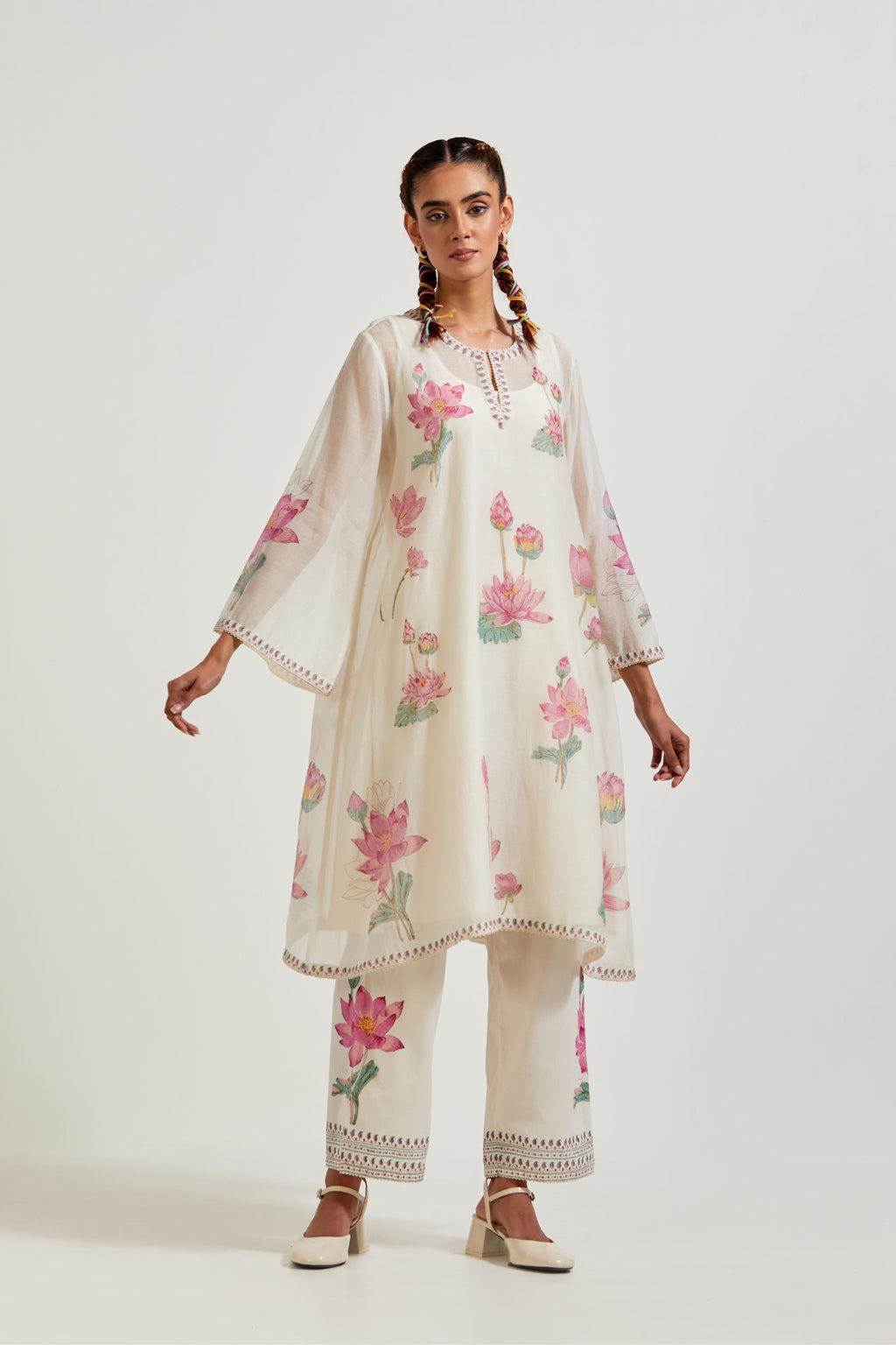 Off white cotton chanderi A-line kurta set features with all-over pink and green lotus flower hand block print.