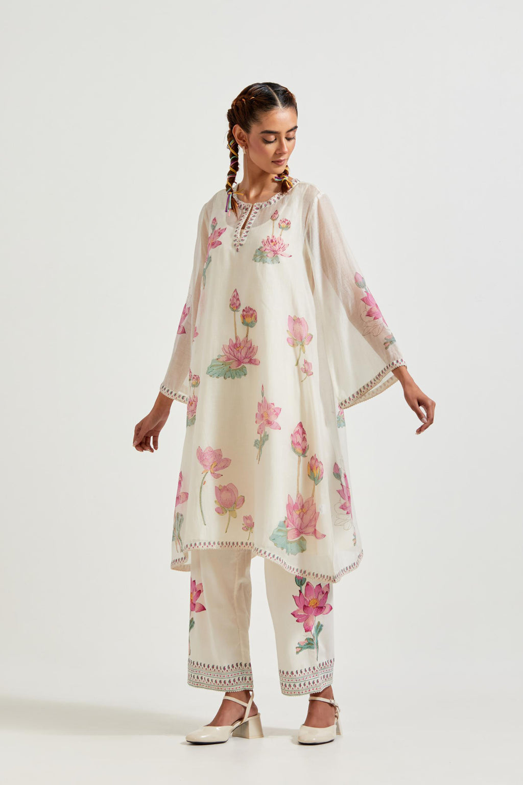 Off white cotton chanderi A-line kurta set features with all-over pink and green lotus flower hand block print.